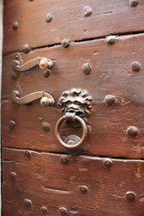 Scary door knocker in Volterra, Tuscany, Italy