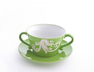 Fototapeta premium Empty green cup on a saucer