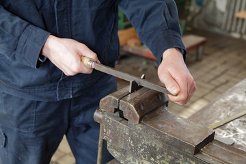 Hands of manual worker  grinding metal in metal industry