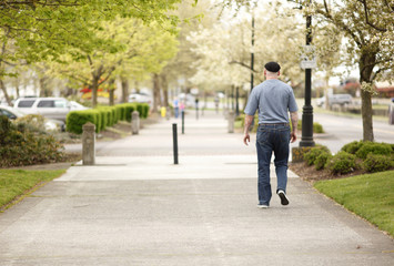 Man walking on a boardwalk.