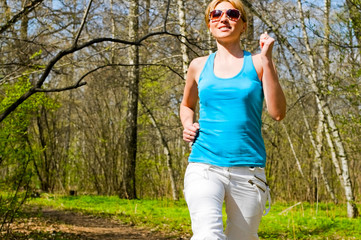 young woman running in forest