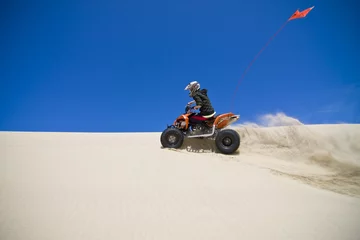 Foto op Aluminium Large sand spray from ATV quadbike rider in the dunes © Raven