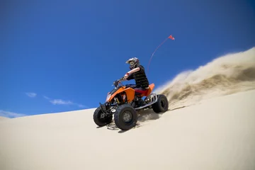 Fotobehang Big sand spray from ATV quadbike rider in the dunes © Raven