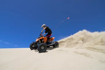 Foto op Aluminium Teen male ATV rider spraying fine sand in the dunes © Raven