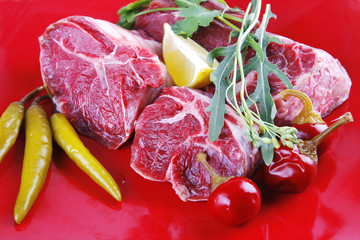 uncooked meat medallion on red