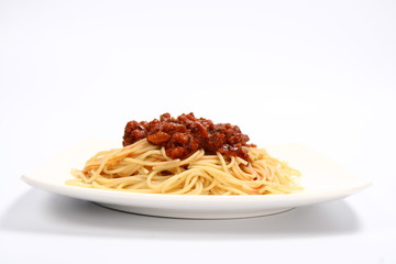 Pasta bolognese on a plate on white background