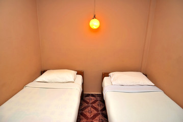 Twin beds in dark hotel room