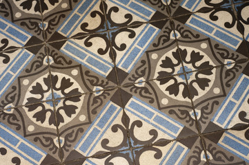 Old floor tile pattern in brown and blue