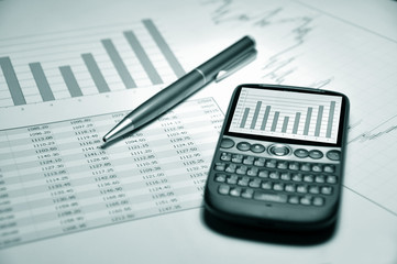Smartphone and pen on a market report