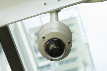 A dome-type security camera mounted on a ceiling