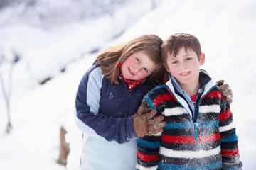 Fototapeta na wymiar Portrait Of Two Children In Snowy Landscape