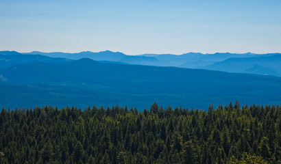 Scenic view of mountains with forest in foreground