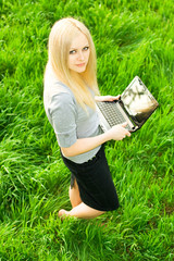 beautiful business woman with the laptop has a rest in the field