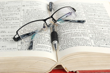 dictionary & pen with glasses