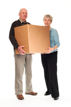 Senior Couple Carrying Home Moving Box