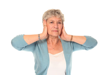 Senior older woman covering ears