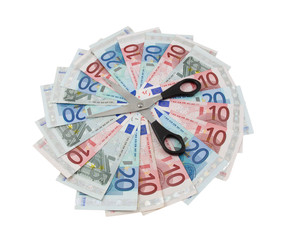 Euro banknotes and scissors over white