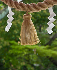 A rope and folded paper outside a shrine in Japan