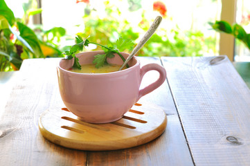 A cup of soup on a background of green