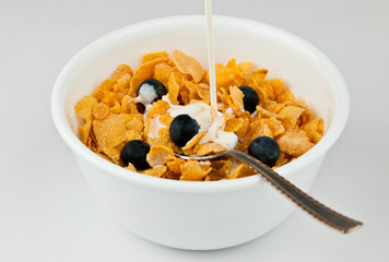 Pouring Milk Into Bowl Of Cereal