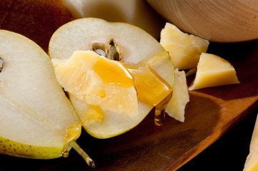 pears with honey over cheese close up