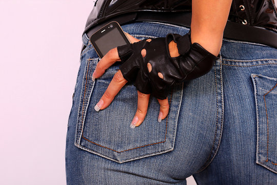 Female Hand Holding A Cell Phone In Back Pocket