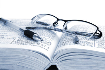dictionary & pen with glasses