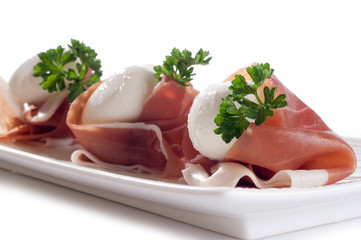slice parma ham with mozzarella on dish