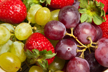 Naklejka na ściany i meble Fresh strawberries and grapes