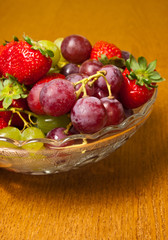 Fototapeta na wymiar Fresh strawberries and grapes