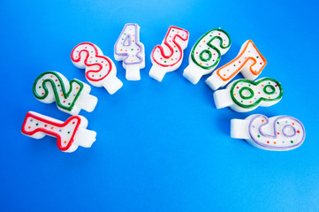 Birthday candles against colourful background