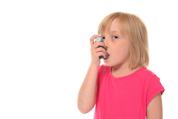 Young little girl using inhaler