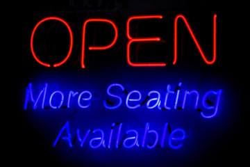 Fototapeta na wymiar OPEN More Seating Available neon sign