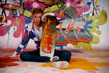 Boy skateboard, graffiti wall