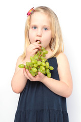 beautiful girl eats green grapes. Series