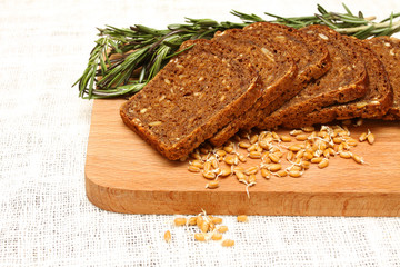 Bread, rosemary and wheat germ on a wooden board