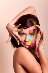 Young brunette woman with colorful makeup