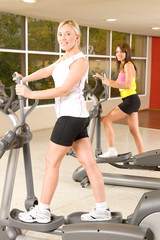 Girls burning calories on treadclimber