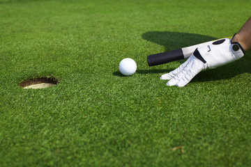 Aiming golf ball to a hole like billiard - 22624374