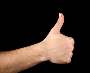 Thumb up hand isolated on black background