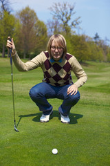 Woman on the golf course preparing for a swing