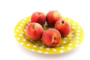 Nectarines on spotted plate
