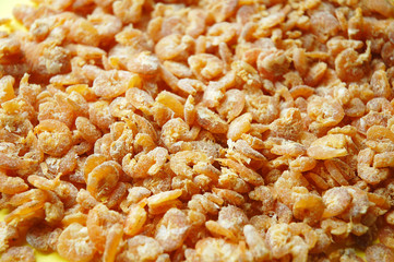 close up of dried shrimps with yellow background