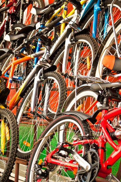 A lot of multi-coloured bicycles for sale.