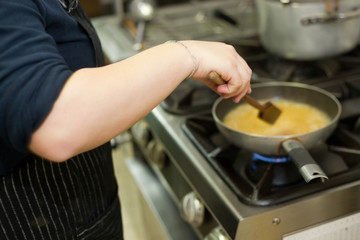 cooking beer risotto in restaurant kitchen