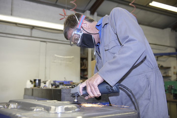 Worker with angle grinder