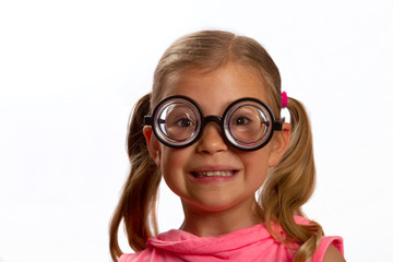 Little girl wearing big round glasses and smiling