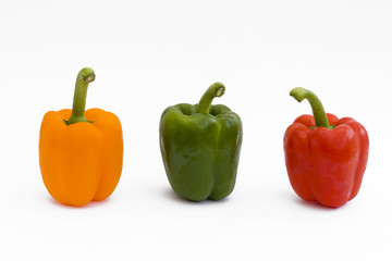red yellow and green peppers on white