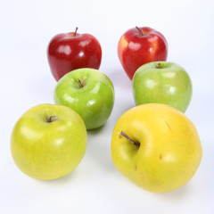 Six apples (two green, two yellow, two red) in raws on white