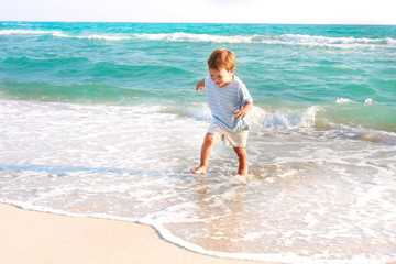 happy boy running in the sea